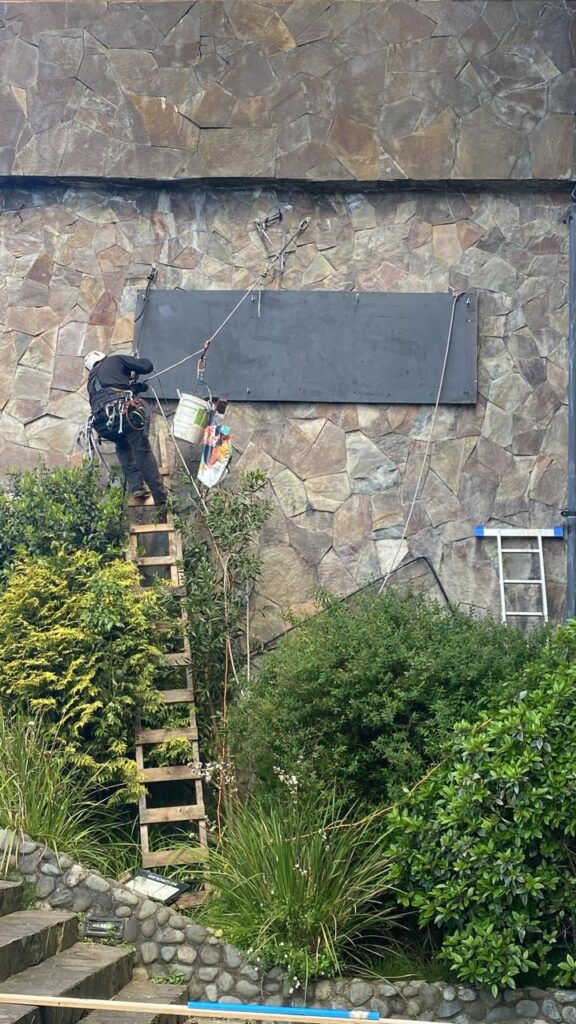 Técnico trabajando en altura durante el montaje del letrero